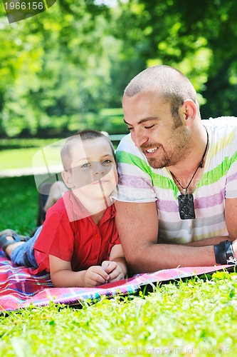 Image of happy father and son have fun at park