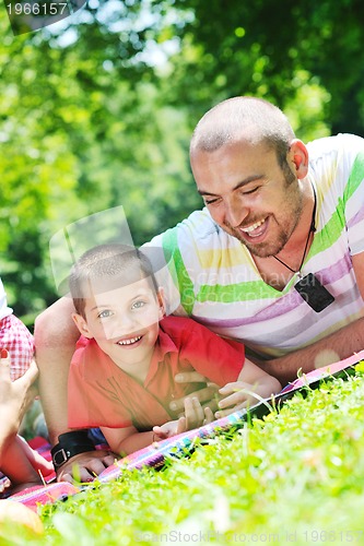 Image of happy father and son have fun at park