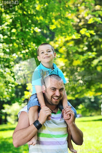 Image of happy father and son have fun at park