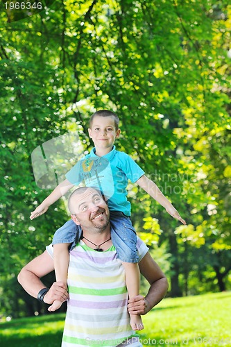 Image of happy father and son have fun at park