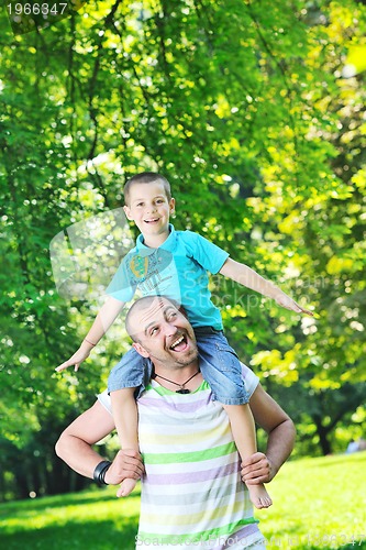 Image of happy father and son have fun at park