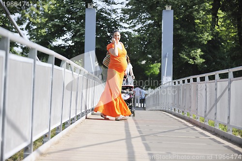 Image of happy pregnant woman talking by cellphone