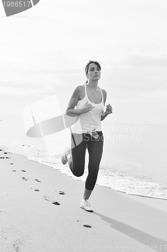 Image of woman running on beach