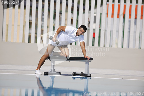 Image of young man exercise at poolside