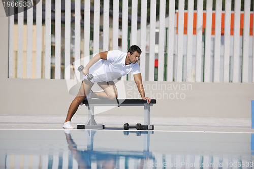 Image of young man exercise at poolside