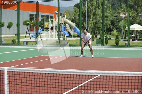 Image of young man play tennis outdoor