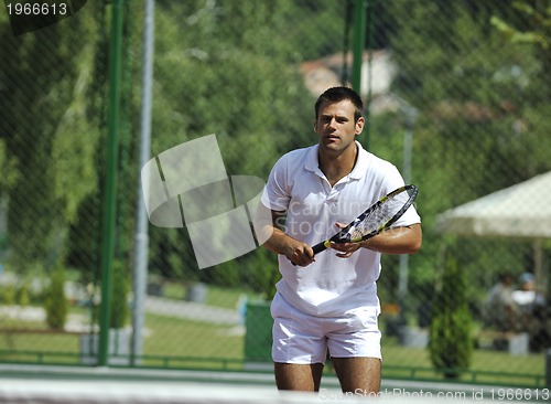 Image of young man play tennis outdoor