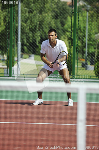 Image of young man play tennis outdooryoung man play tennis outdoor