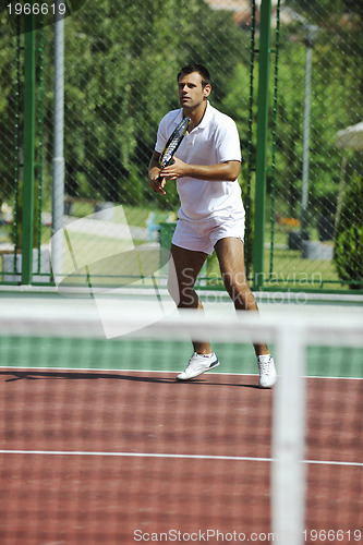 Image of young man play tennis outdooryoung man play tennis outdoor