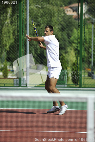 Image of young man play tennis outdooryoung man play tennis outdoor