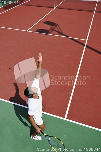 Image of young man play tennis outdoor