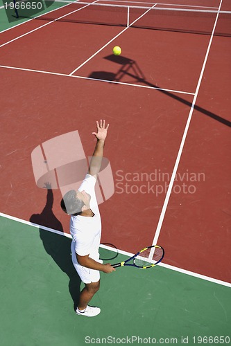 Image of young man play tennis outdoor