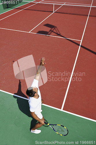 Image of young man play tennis outdoor