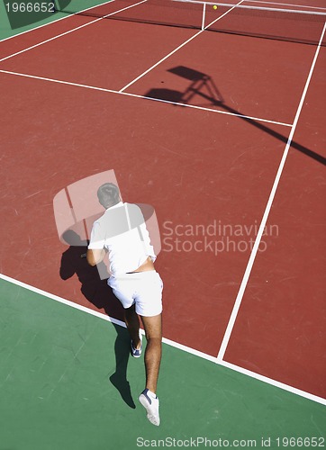 Image of young man play tennis outdoor