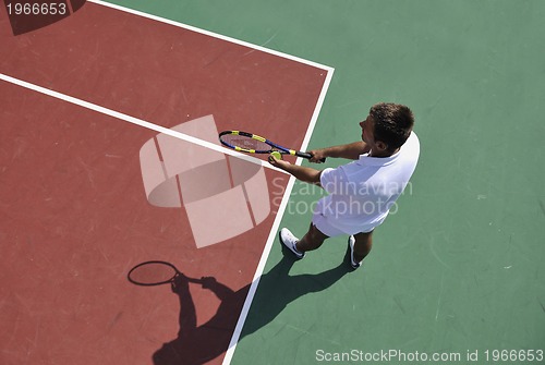 Image of young man play tennis outdoor