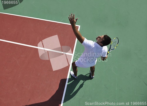Image of young man play tennis outdoor