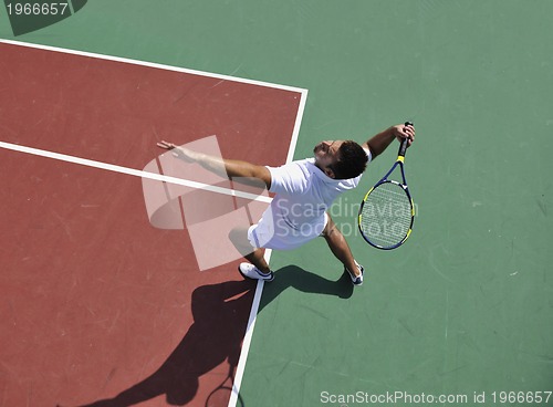 Image of young man play tennis outdoor