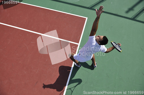 Image of young man play tennis outdoor