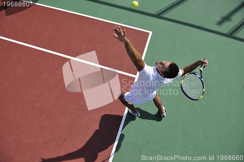 Image of young man play tennis outdoor