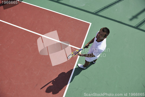 Image of young man play tennis outdoor