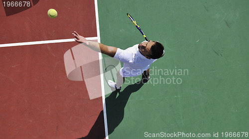 Image of young man play tennis outdoor