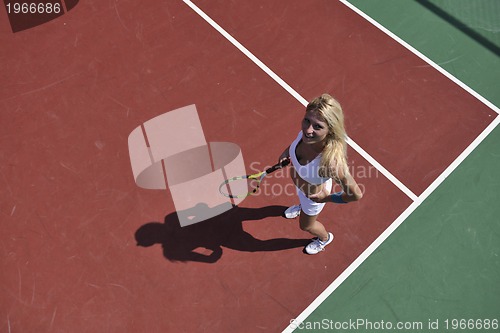 Image of young woman play tennis game outdoor