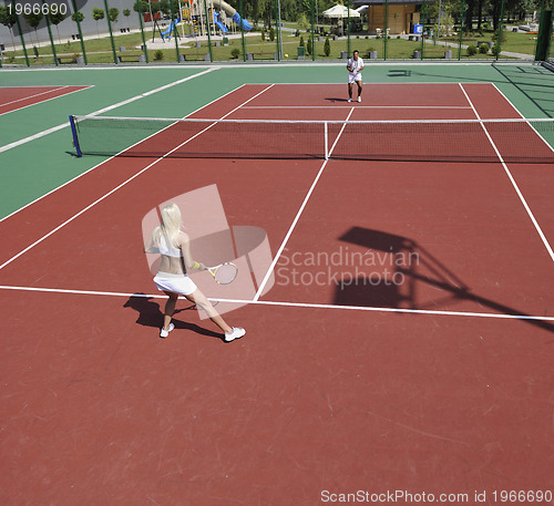 Image of young woman play tennis game outdoor