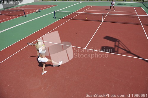 Image of young woman play tennis game outdoor