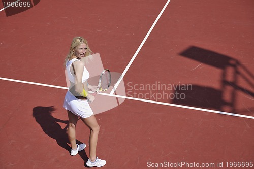 Image of young woman play tennis game outdoor