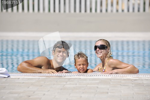 Image of happy young family have fun on swimming pool