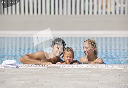 Image of happy young family have fun on swimming pool