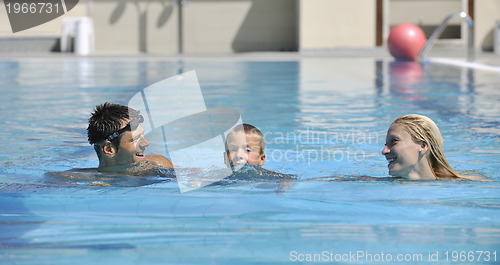 Image of happy young family have fun on swimming pool 