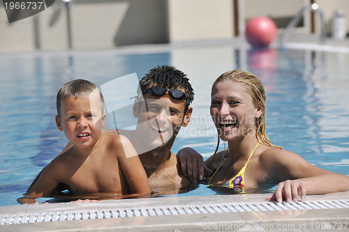 Image of happy young family have fun on swimming pool 