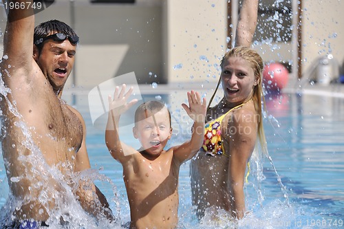 Image of happy young family have fun on swimming pool