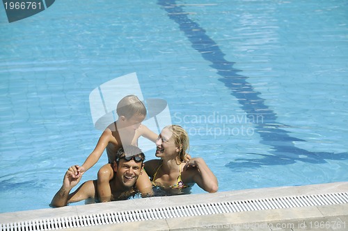 Image of happy young family have fun on swimming pool