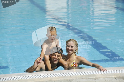 Image of happy young family have fun on swimming pool
