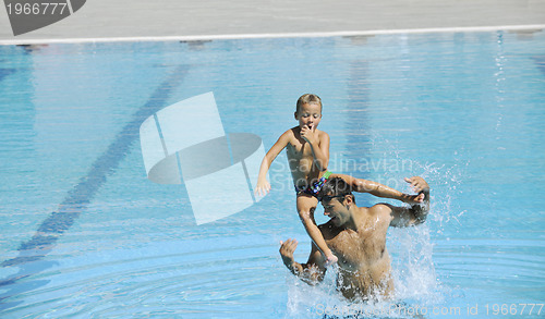 Image of happy father and son at swimming pool