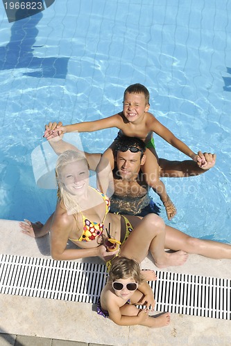 Image of happy young family have fun on swimming pool