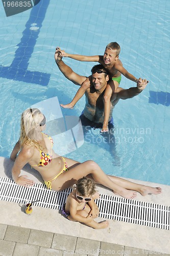 Image of happy young family have fun on swimming pool