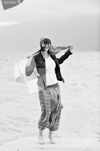 Image of beautiful young woman on beach with scarf