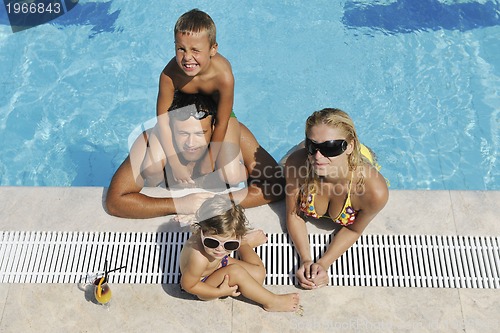 Image of happy young family have fun on swimming pool