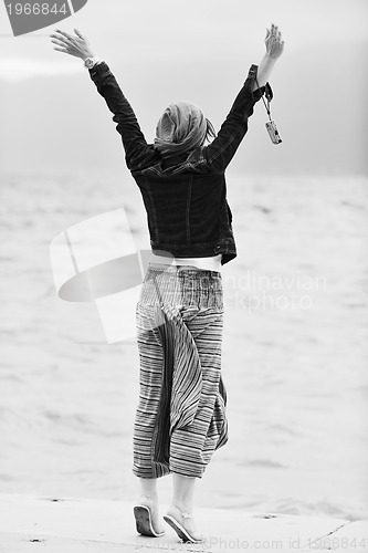 Image of beautiful young woman on beach with scarf