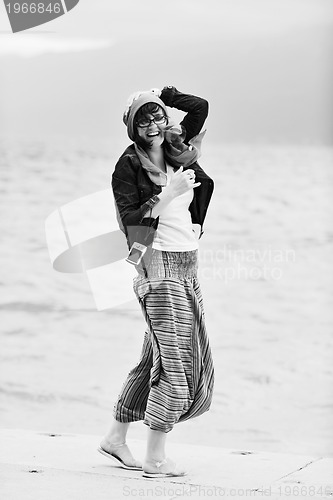 Image of beautiful young woman on beach with scarf