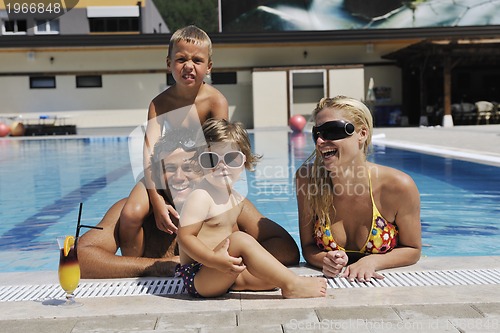 Image of happy young family have fun on swimming pool 