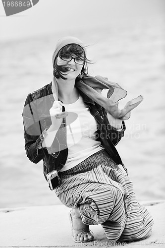 Image of beautiful young woman on beach with scarf