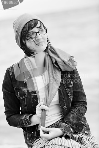 Image of beautiful young woman on beach with scarf