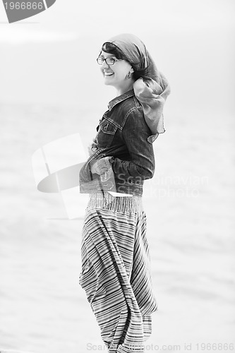 Image of beautiful young woman on beach with scarf