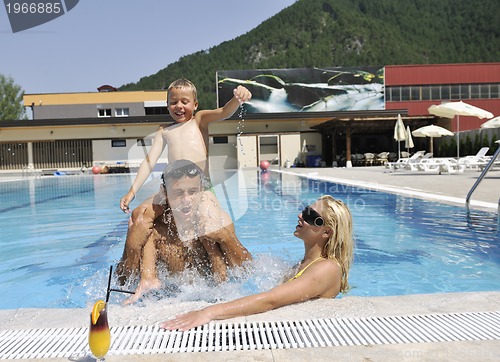 Image of happy young family have fun on swimming pool