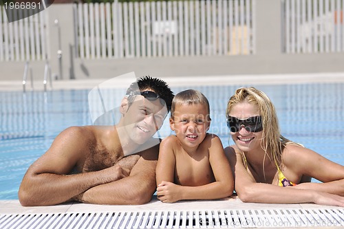 Image of happy young family have fun on swimming pool