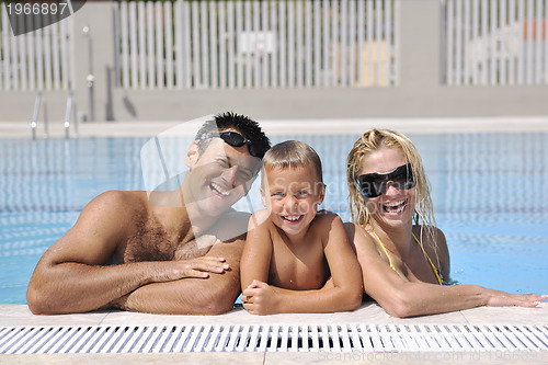 Image of happy young family have fun on swimming pool 